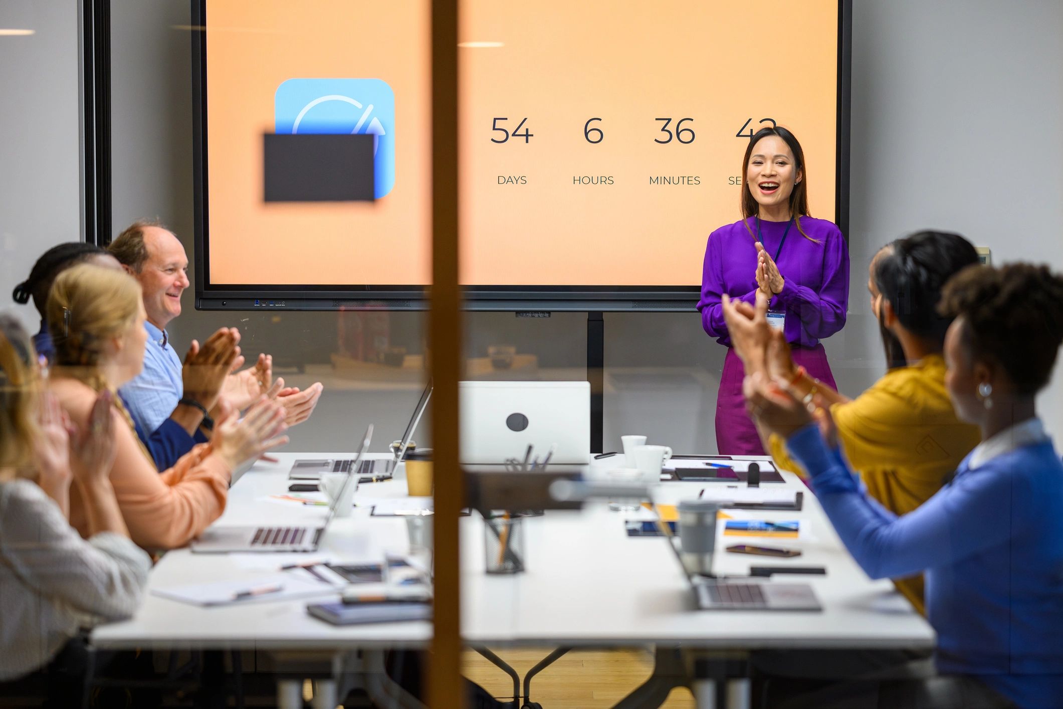 Professionals applauding after a successful workplace presentation